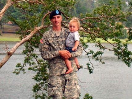 WIN Home Inspector in military uniform, holding his child.