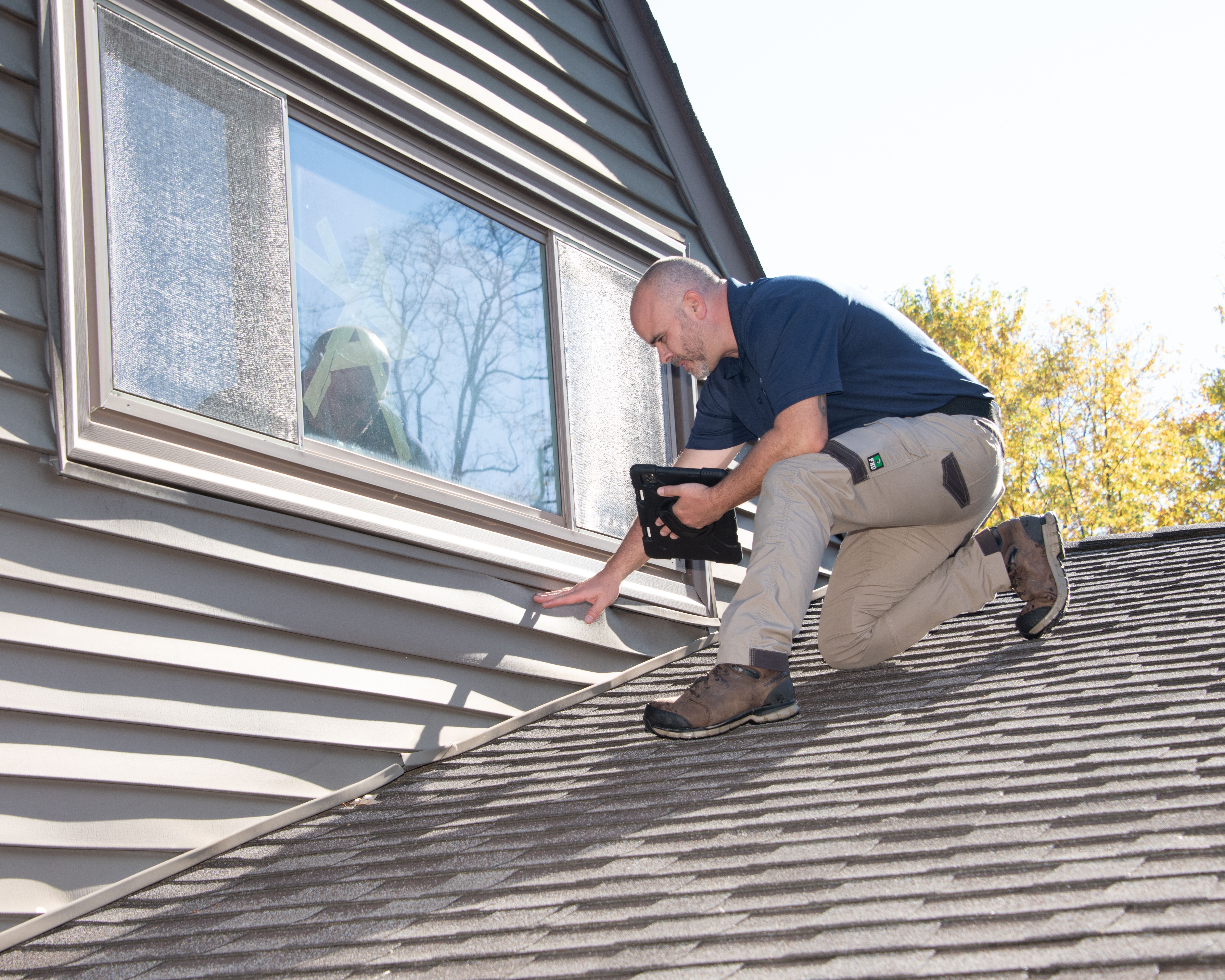 WIN Home Inspector checking the exterior of a house